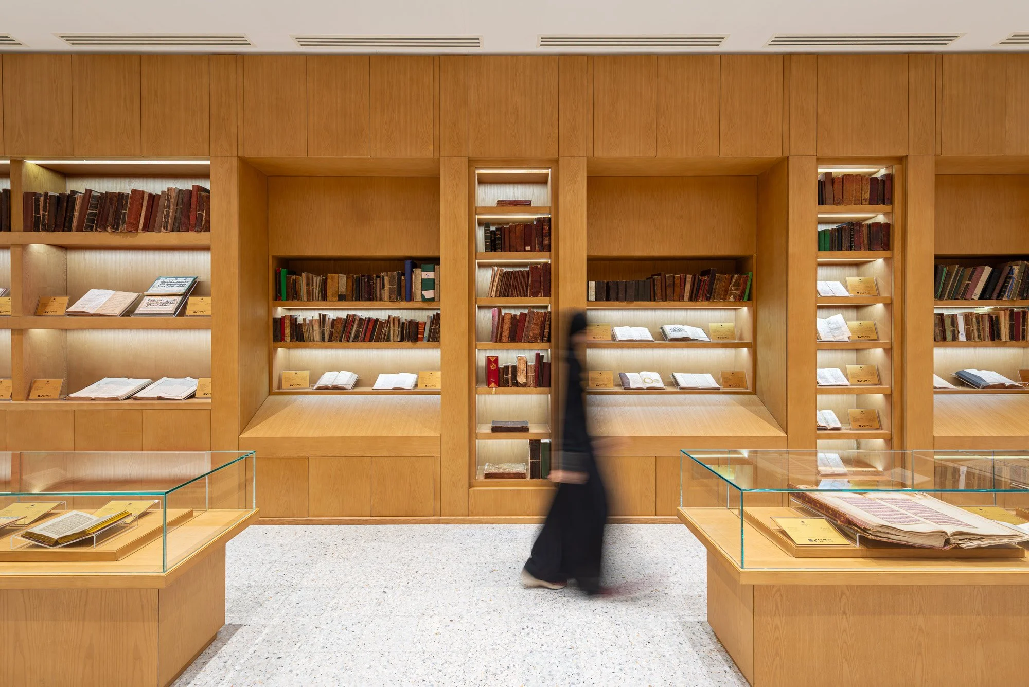 Architectural elevation shot of custom oak shelving wall and glass displays in the Hall of Rare Books at Dar Al Kutub by Hammad Iqbal
