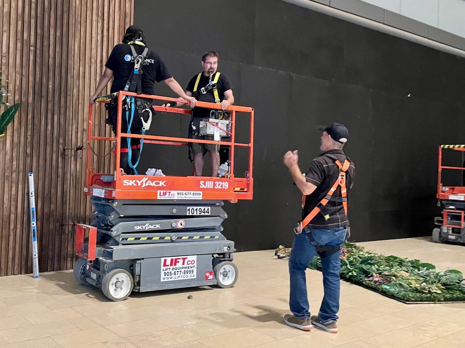 LaFrance Design team on lift installing decor for the Yorkdale Lounge