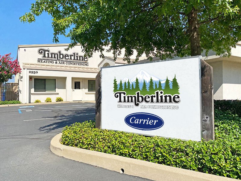 Timberline HVAC's office in Redding CA showing a close up view of their sign with the Timberline logo and Carrier HVAC logo