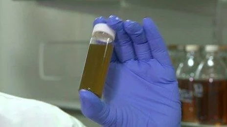 A scientist holds a lab-made vial of Bald’s eyesalve.