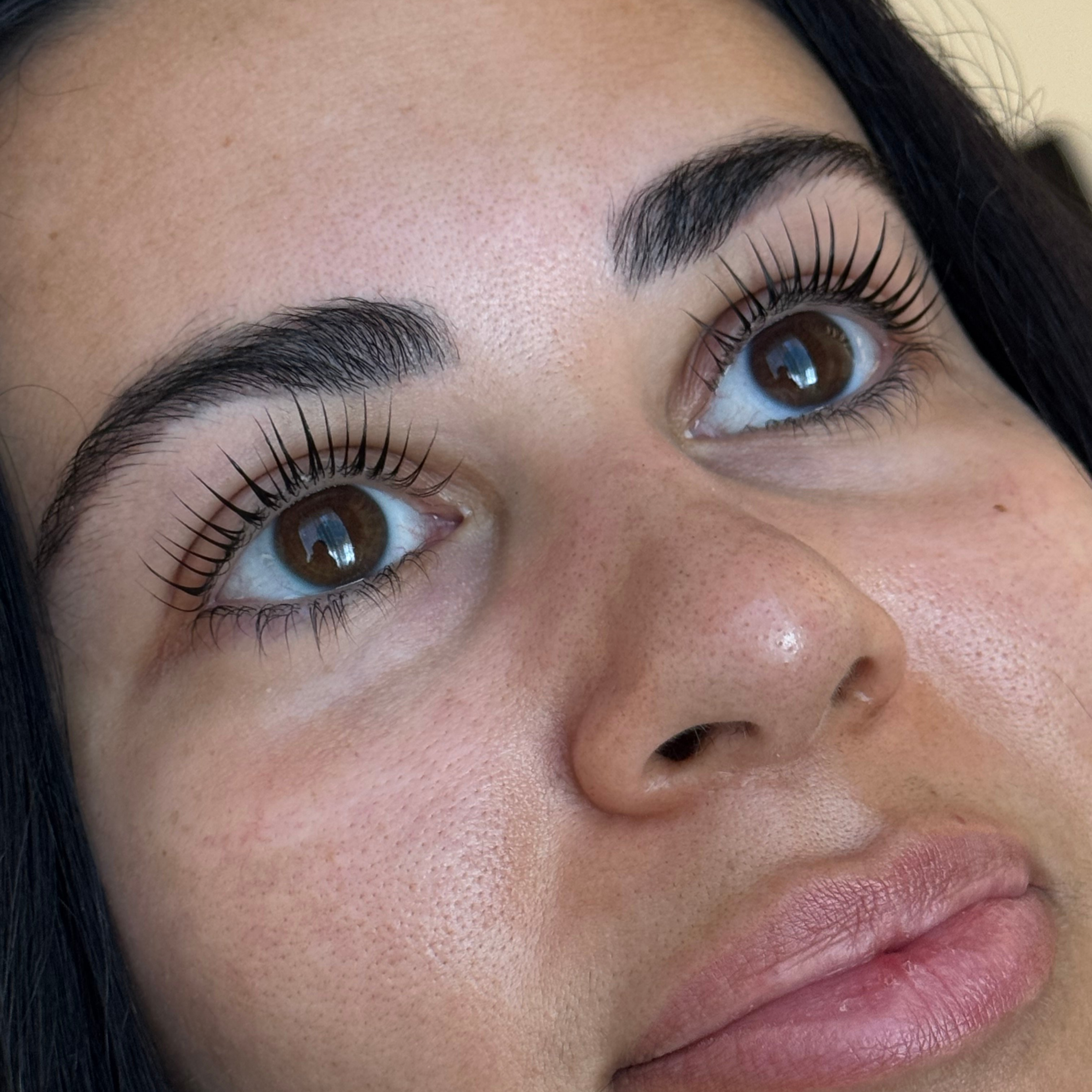 Client with lifted, curled natural lashes after a Korean Lash Lift at Arlis Artistry in Alpharetta