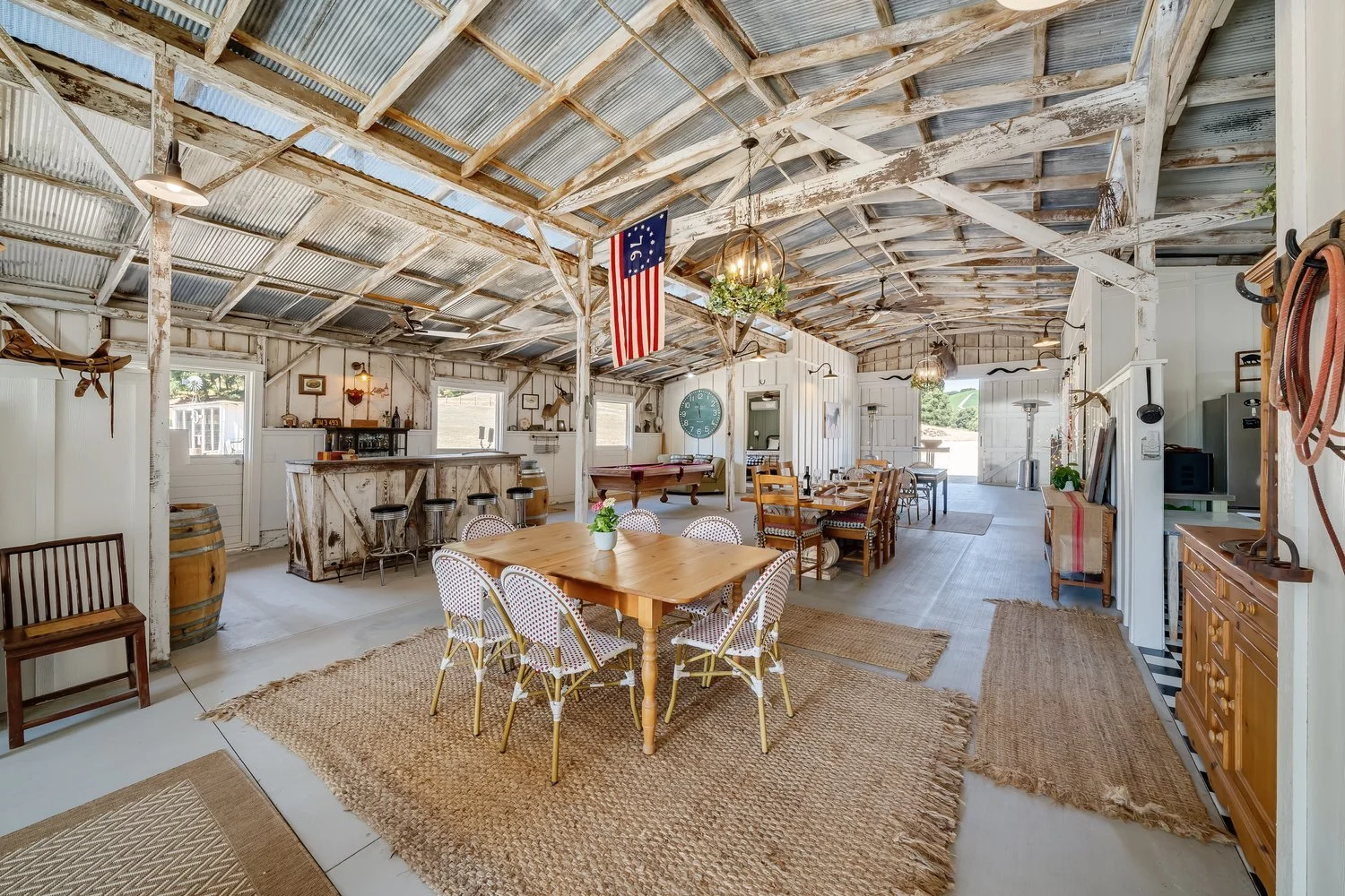 The Barn at Farm Blanc et Rouge features a spacious interior with exposed beams, vintage touches, and an open-concept layout designed for relaxed wine country living