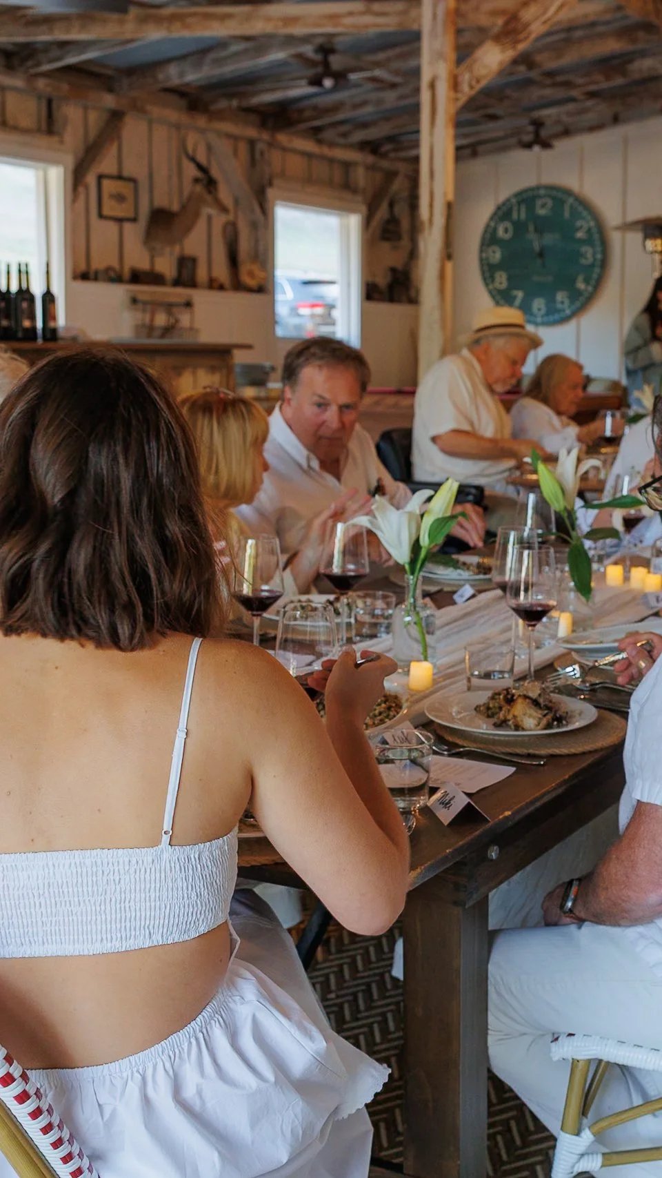 Dinner party inside The Barn at Farm Blanc et Rouge with warm lighting, shared plates, and a cozy, intimate wine country atmosphere