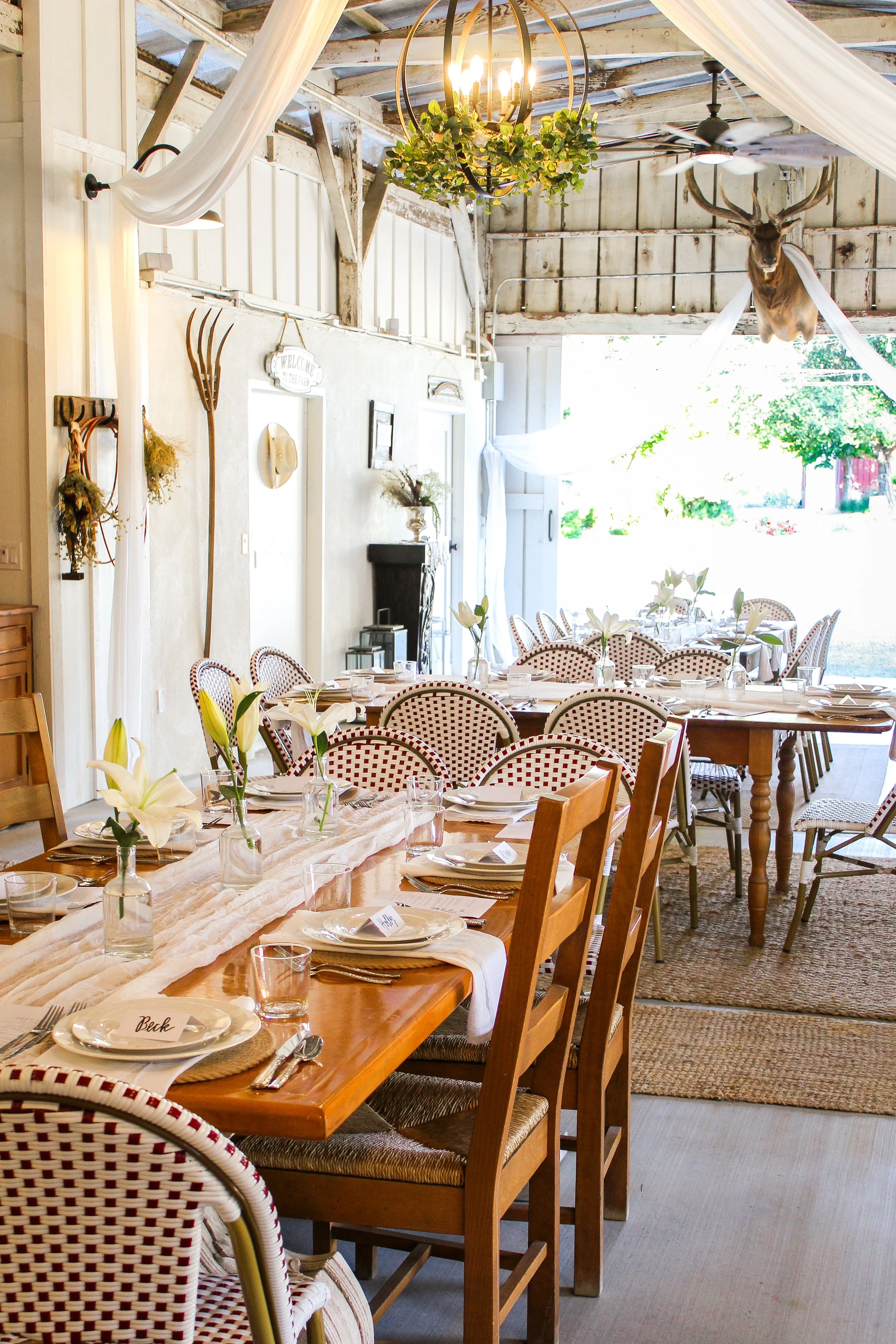 Sunlit dinner tablescape inside The Barn at Farm Blanc et Rouge, styled with natural light, inviting textures, and relaxed wine country charm