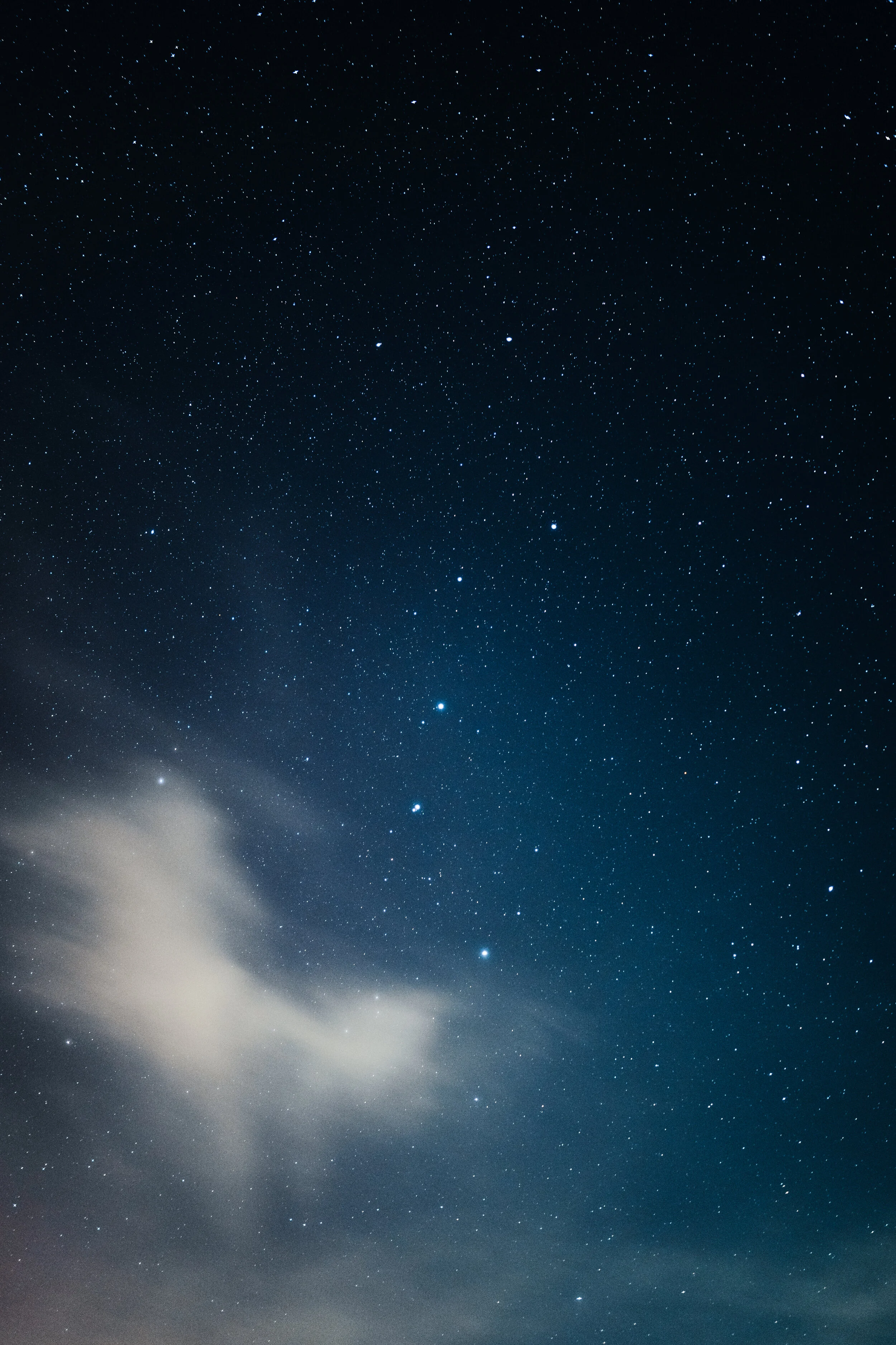 Stars at night with a cloud passing