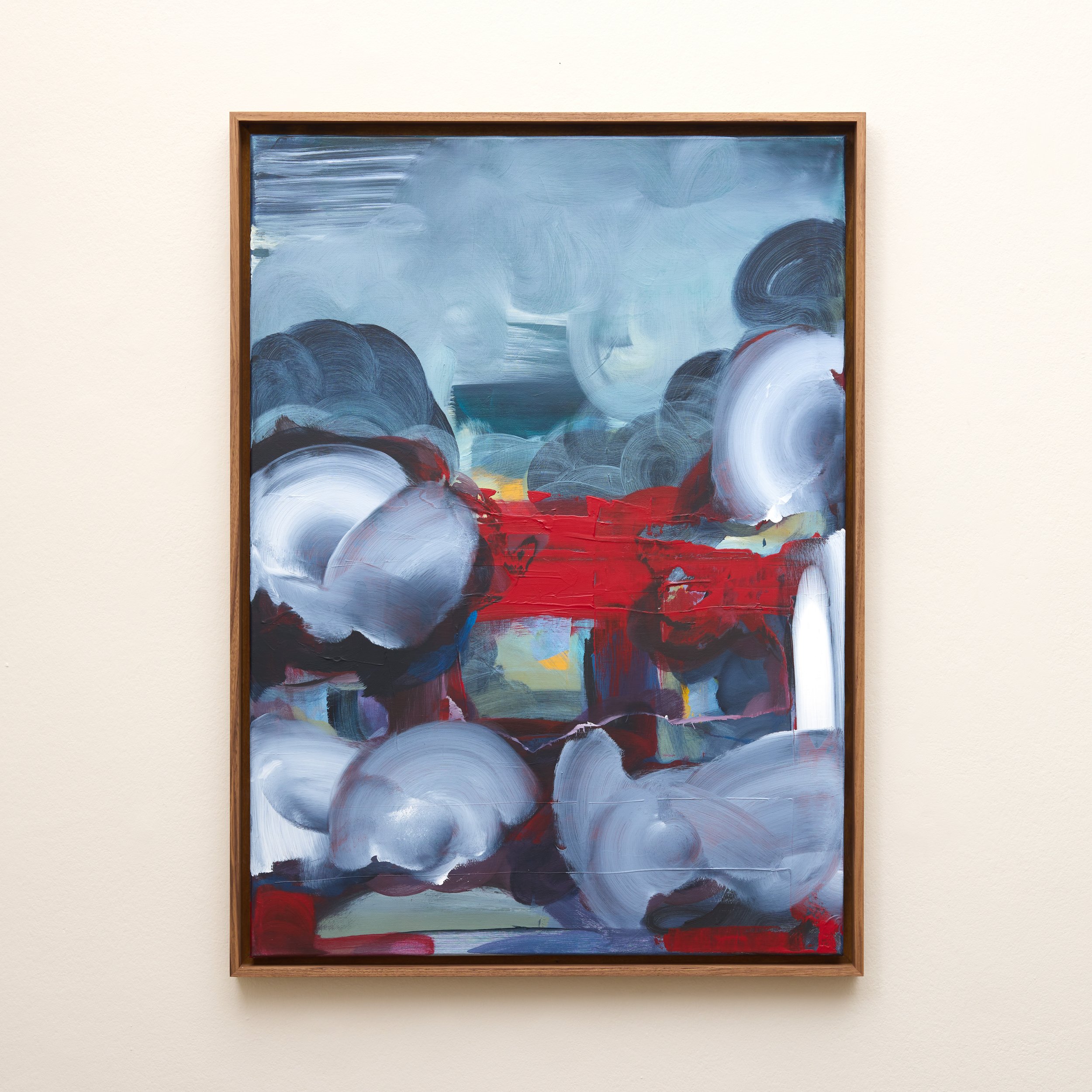 Abstract expressionist painting with blue, white, black, red, and yellow brushstrokes in a wooden frame, displayed on a plain wall.