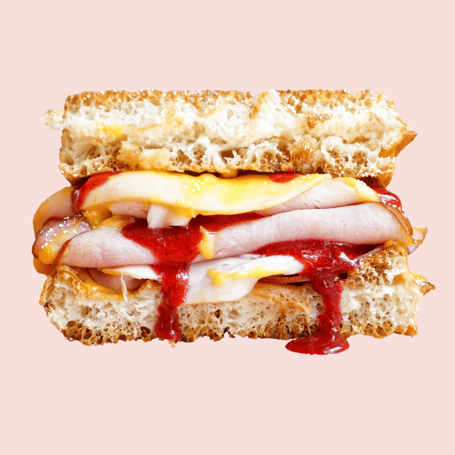 Monte Cristo: sliced ham & turkey, melted cheddar cheese, berry syrup, sandwiched between a waffle (make vegan +3)
