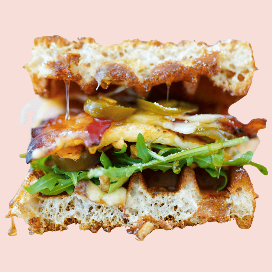 Sweet Heat: egg patty, gouda, swiss, Sweet As Soz hot honey, maple candied bacon, crispy fried onions, jalapénos, arugula, sandwiched between a waffle