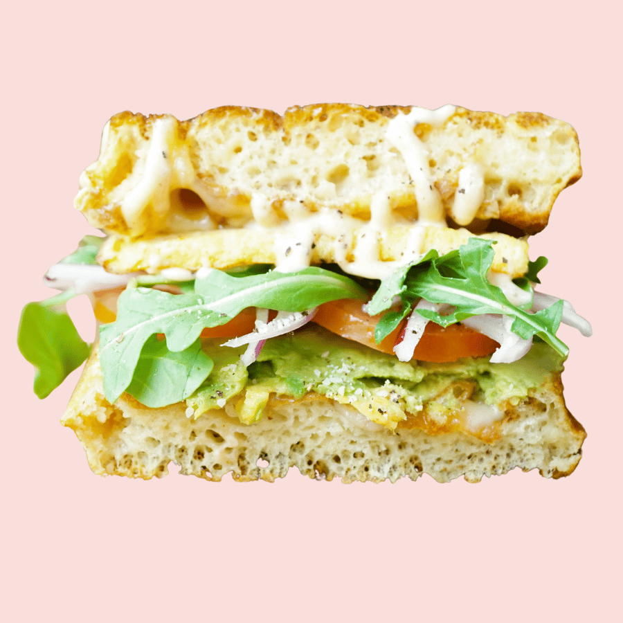 Caleggfornia: scrambled egg patty, gouda, swiss, avocado, tomato, red onion, arugula, garlic aioli, sandwiched between a waffle (make vegan +3)