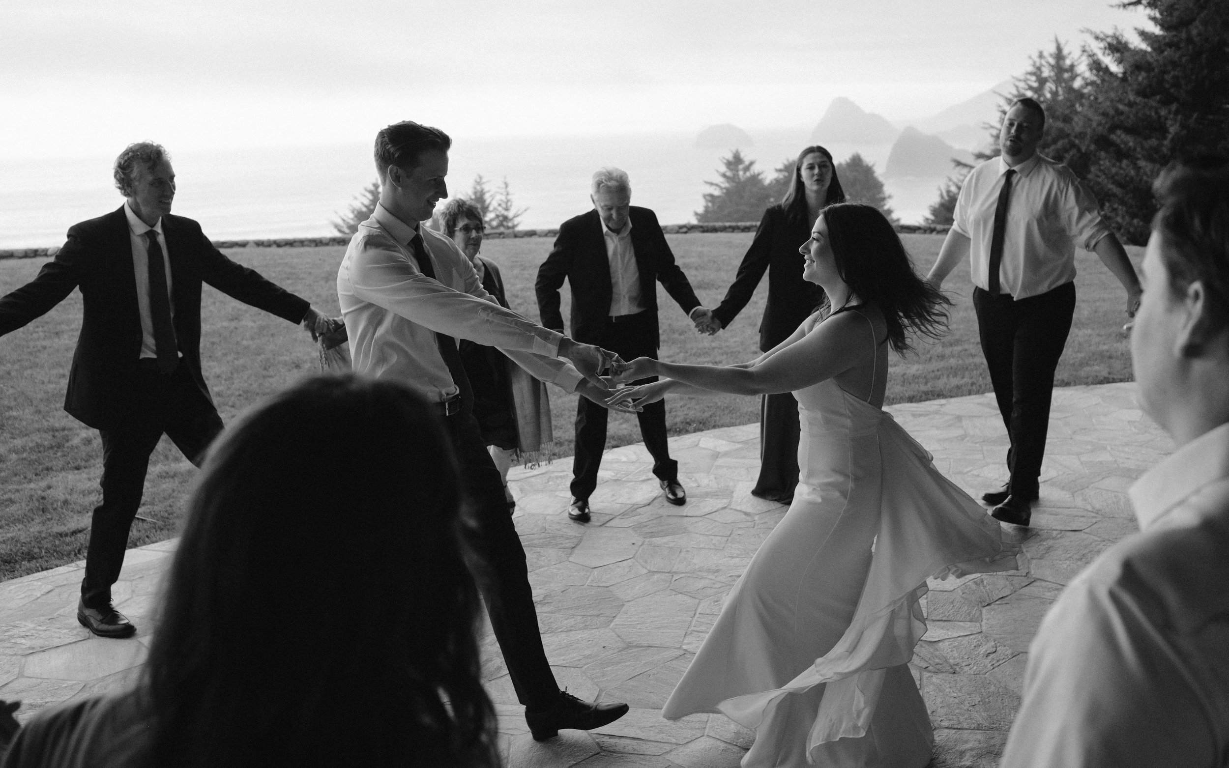 Guests dancing during an intimate Pacific Northwest wedding reception with ocean views.