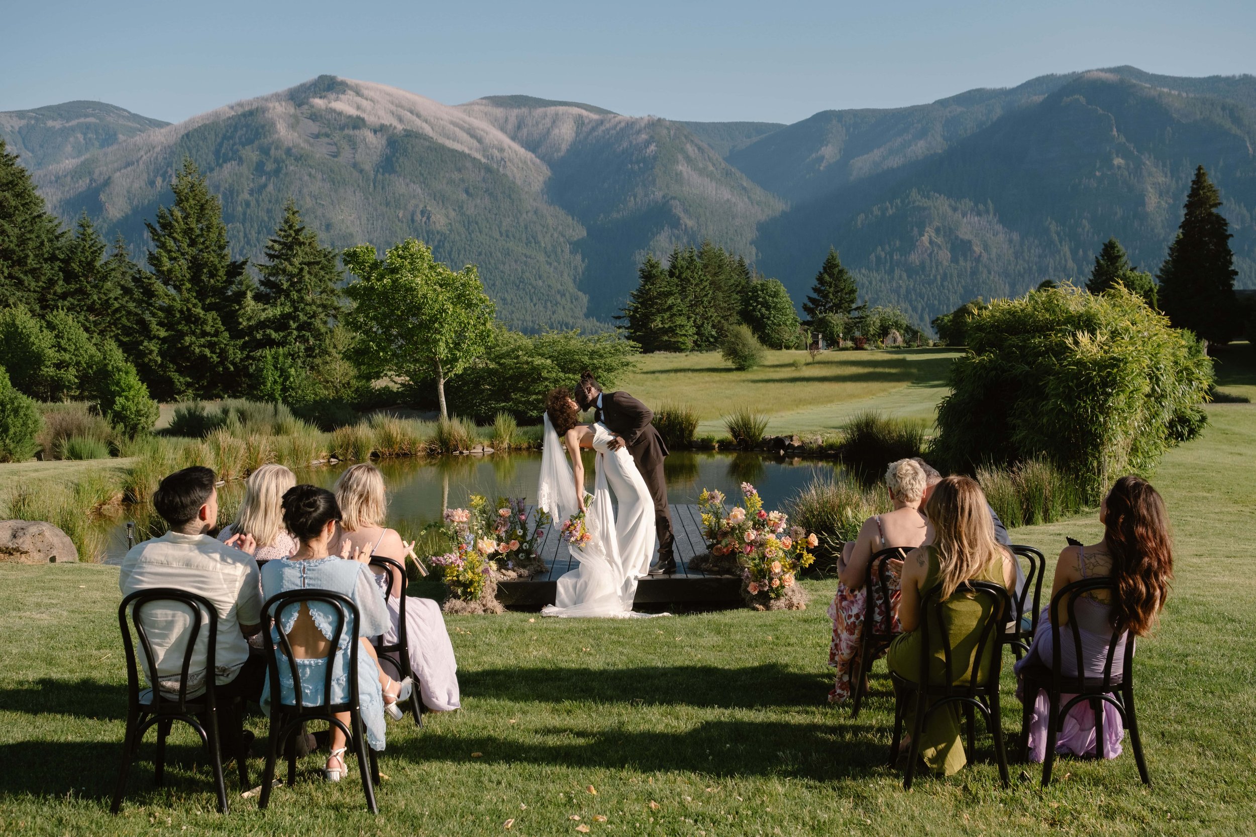 Micro wedding ceremony at a mountain view venue in Washington with guests seated outdoors.