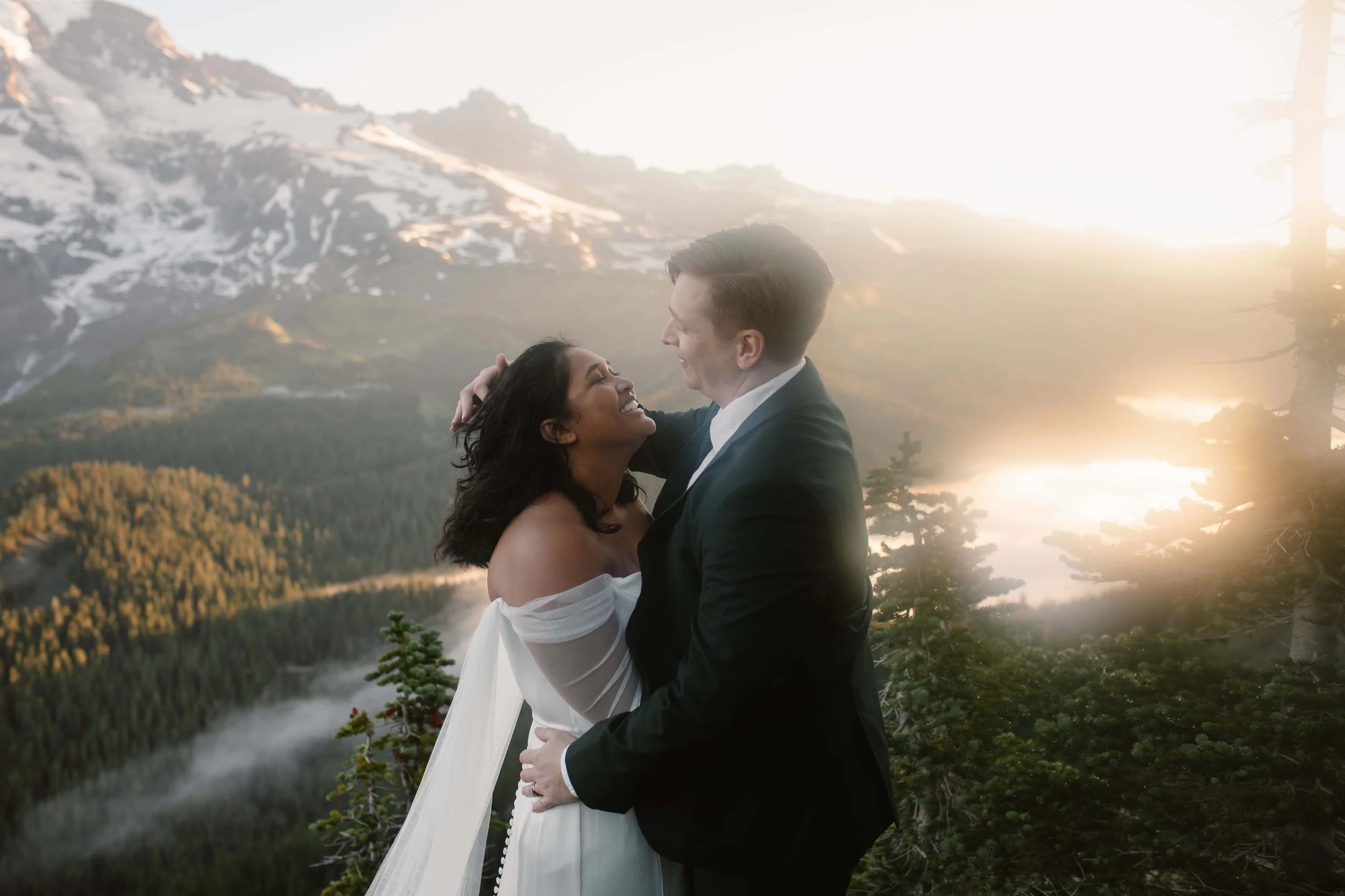 Couple laughing during a mountain elopement in Washington at sunset