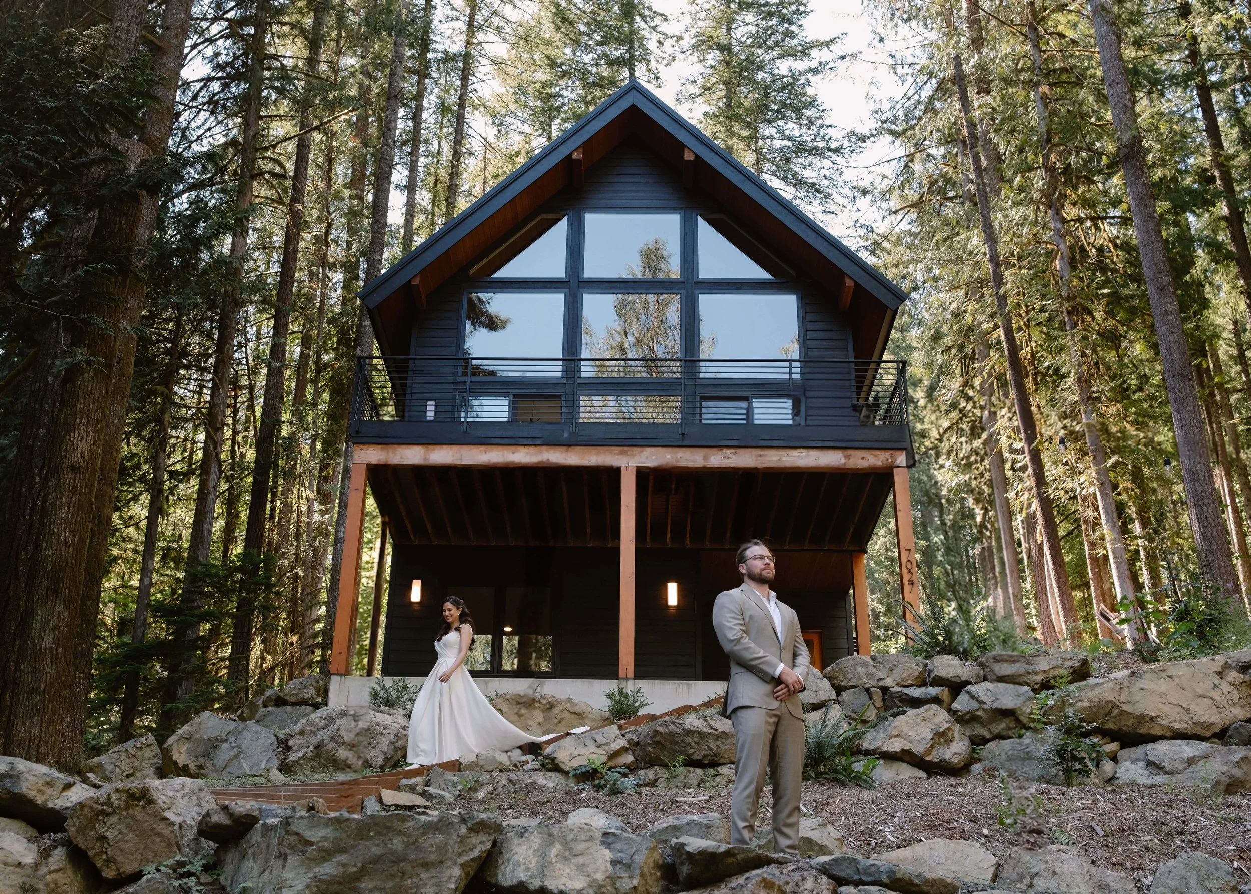 Bride and groom first look in front of forest cabin