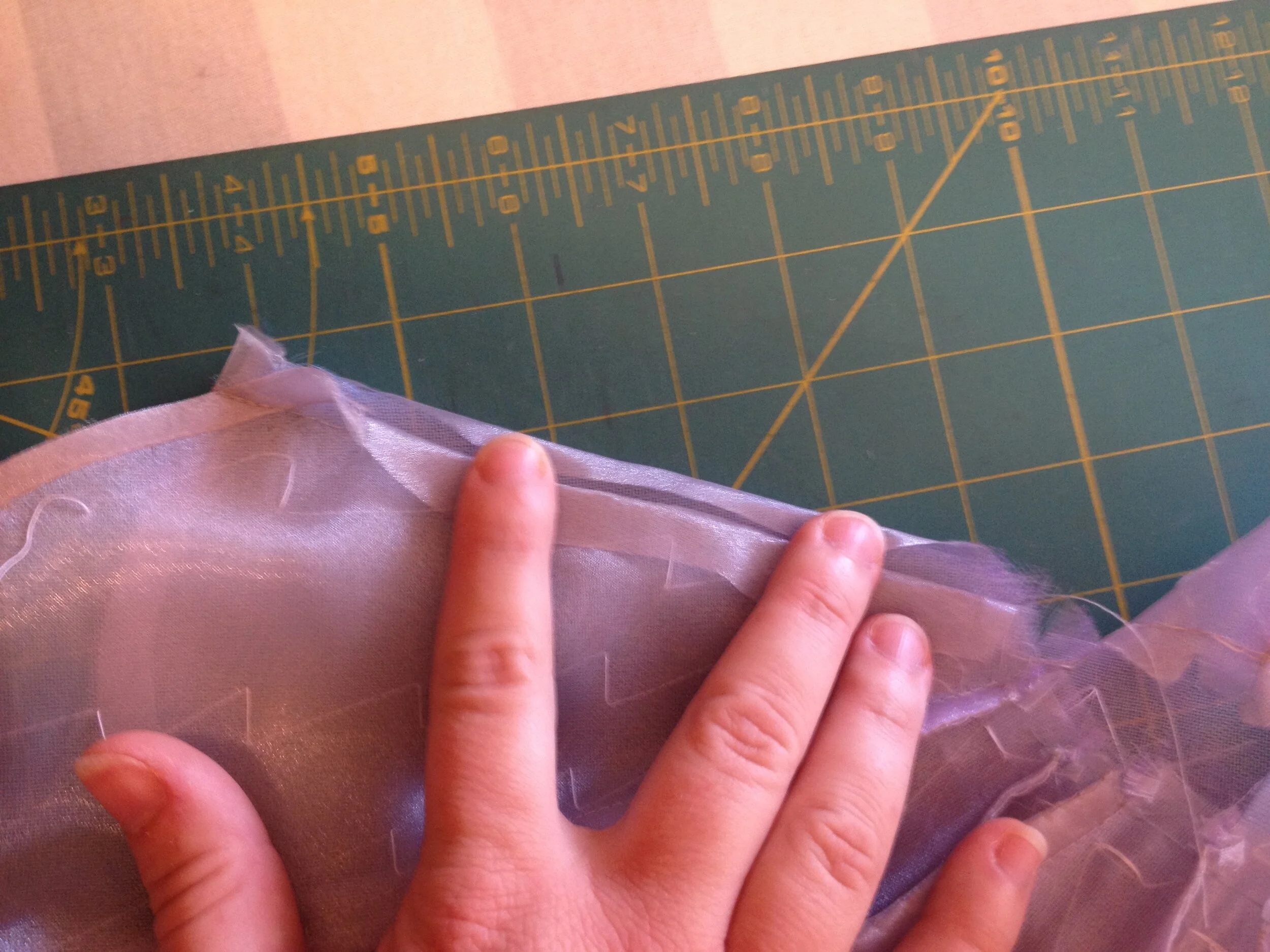 Folding the organza over the tulle and mesh.