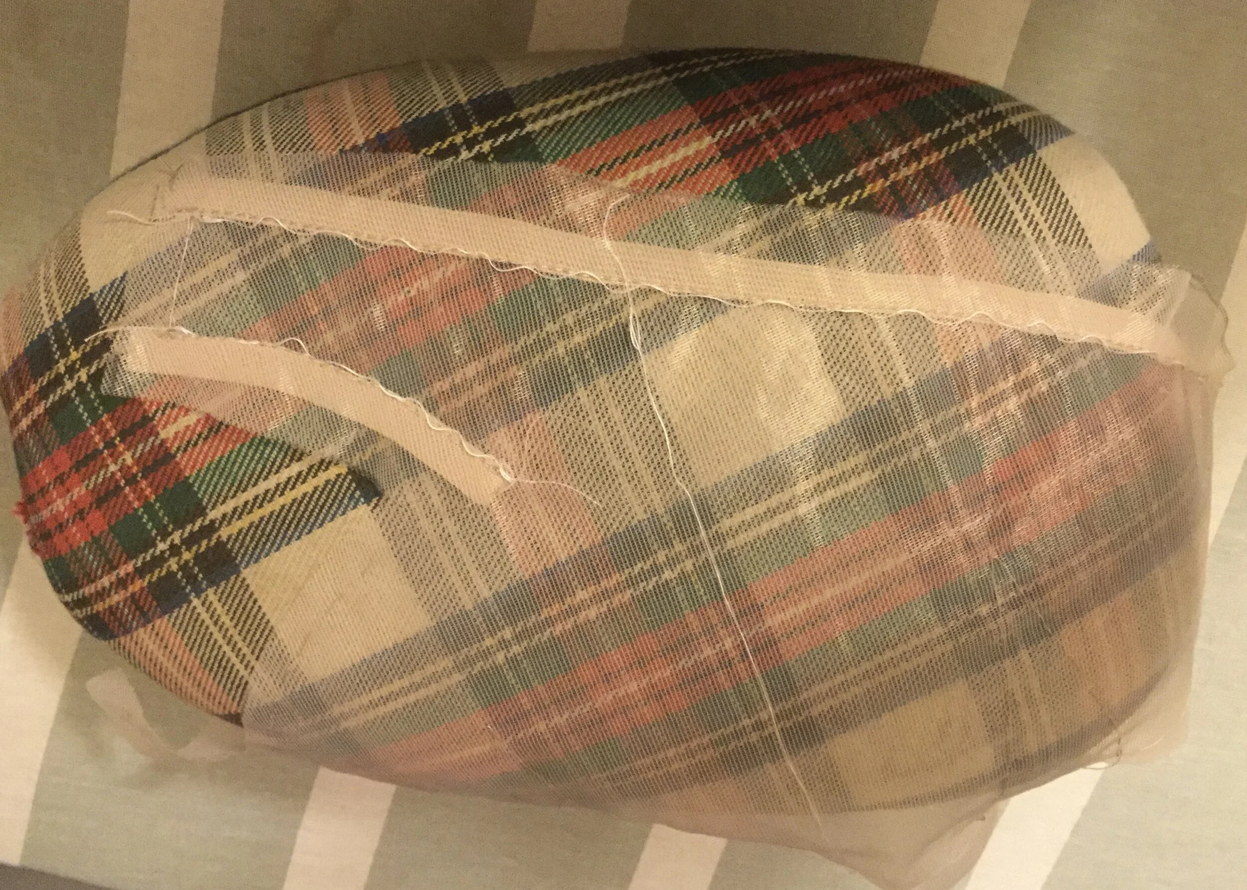 With tape stitched to strap.