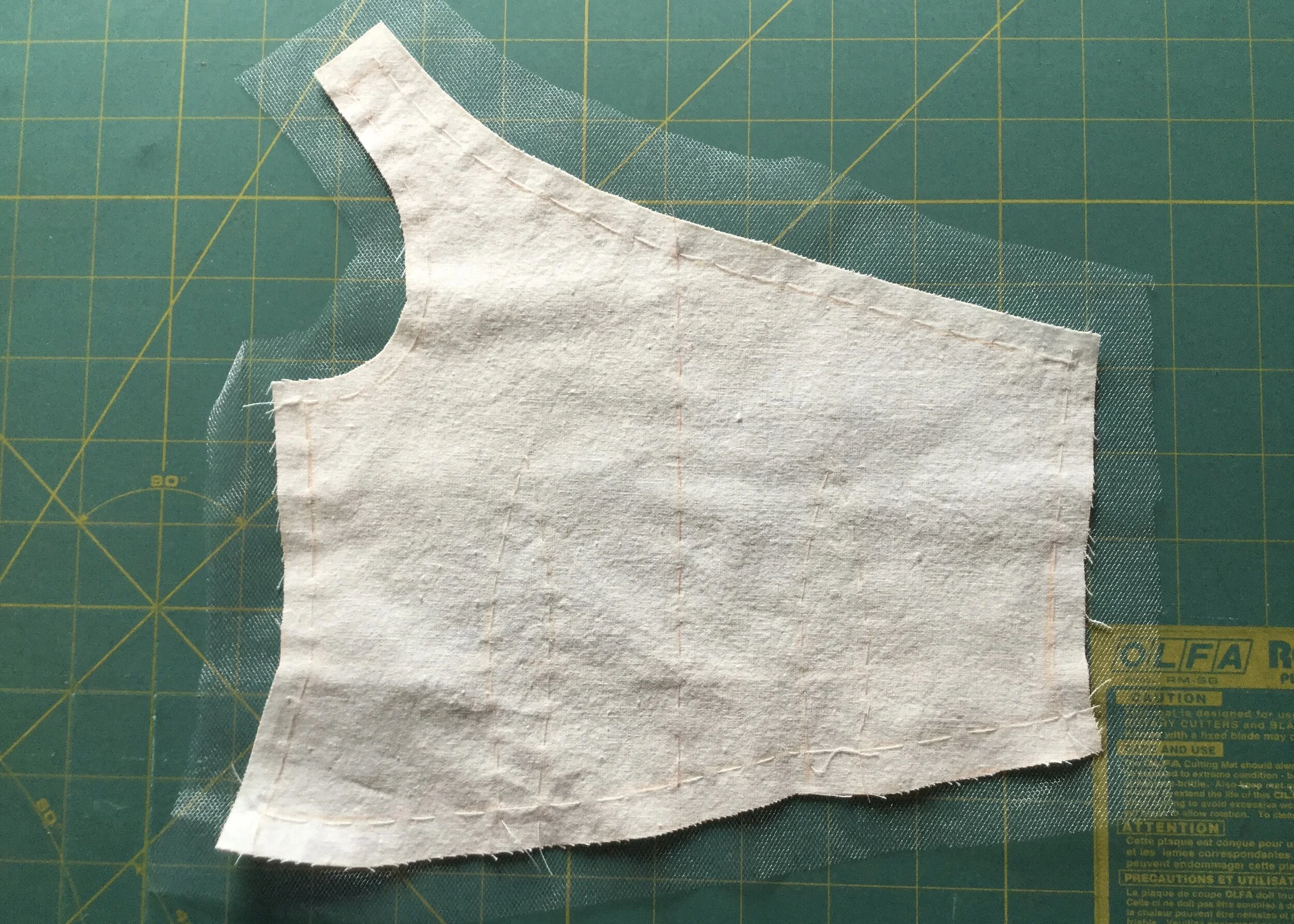 Tulle flat mounted to cotton of bodice front.