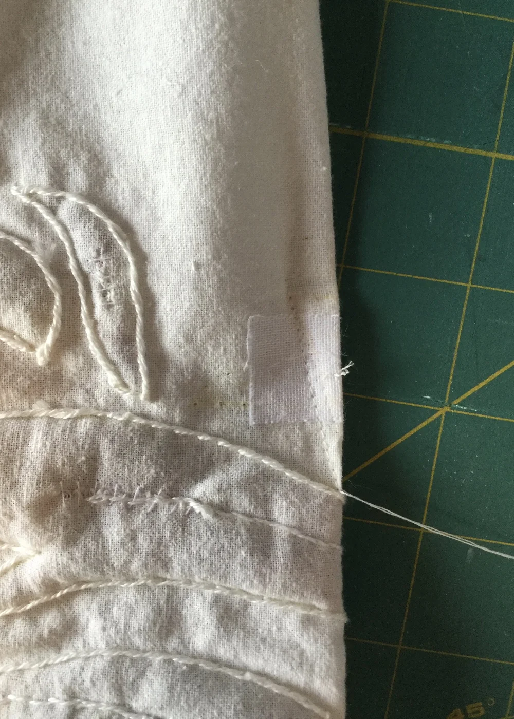 Dart stitched at base of zipper.