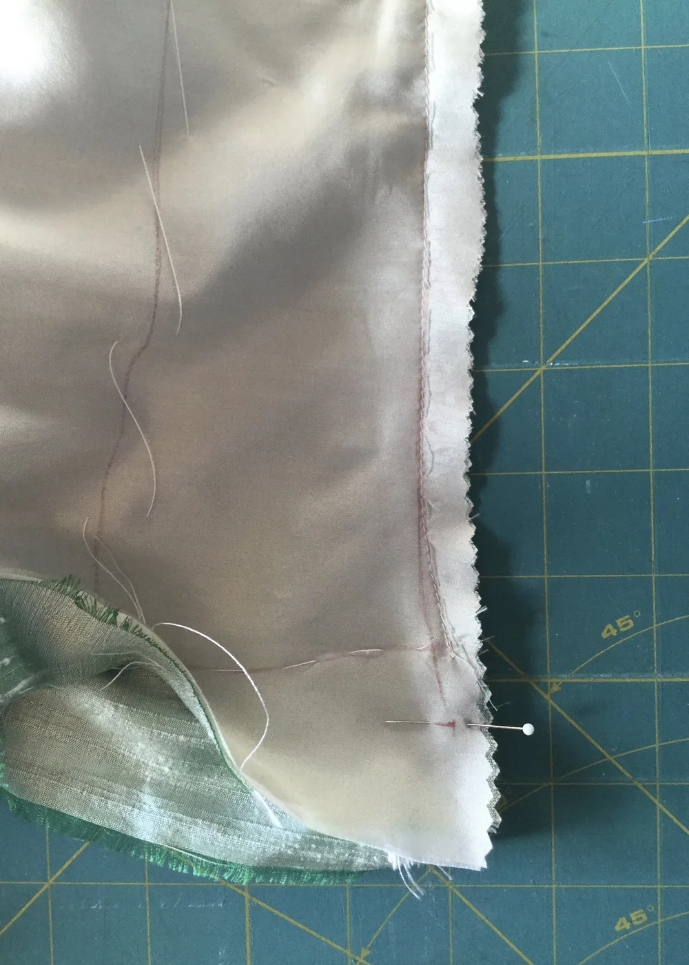 Adjusting the left hemline.