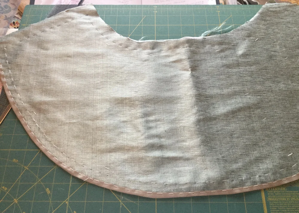 Binding the hem.