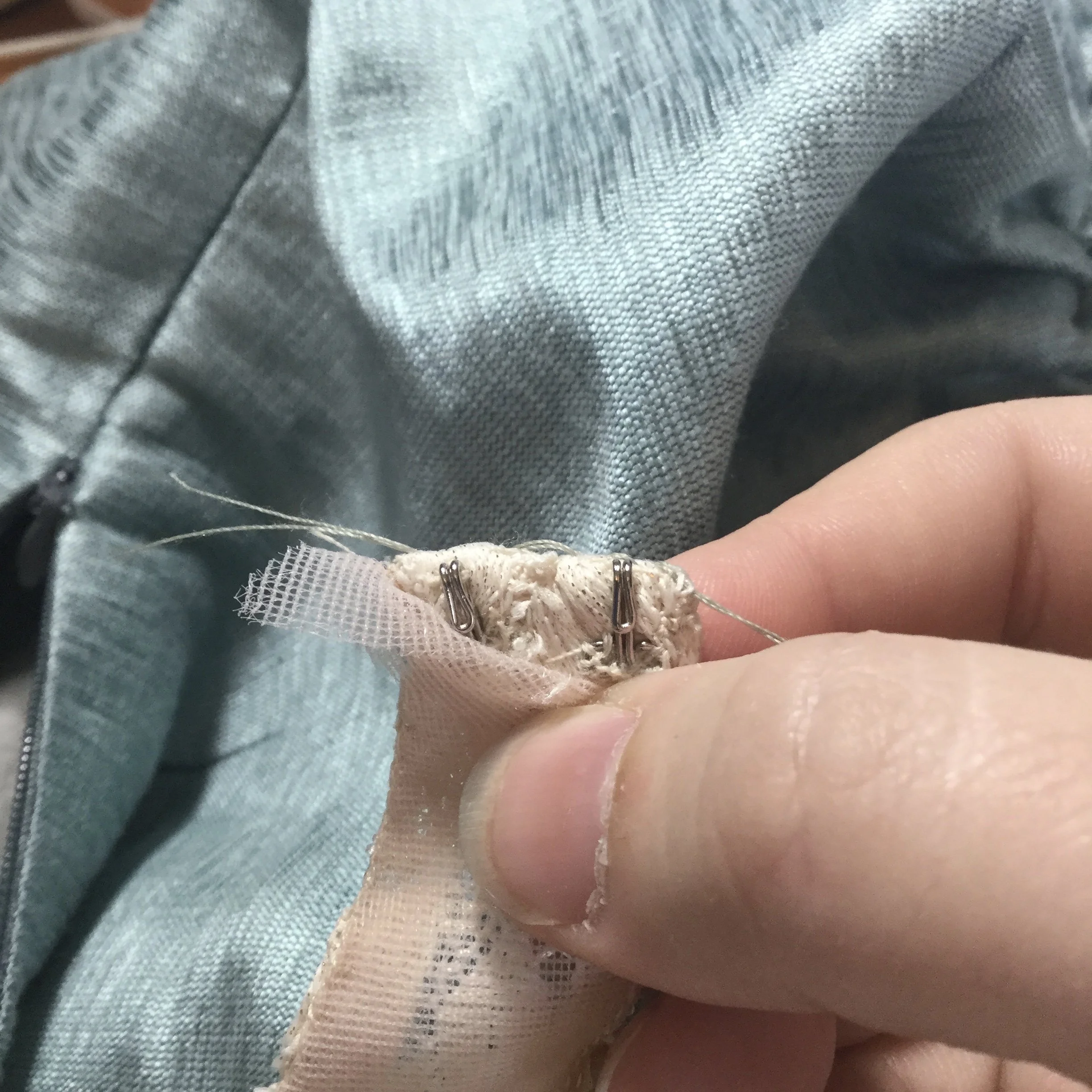 Stitching the hooks to the lace.