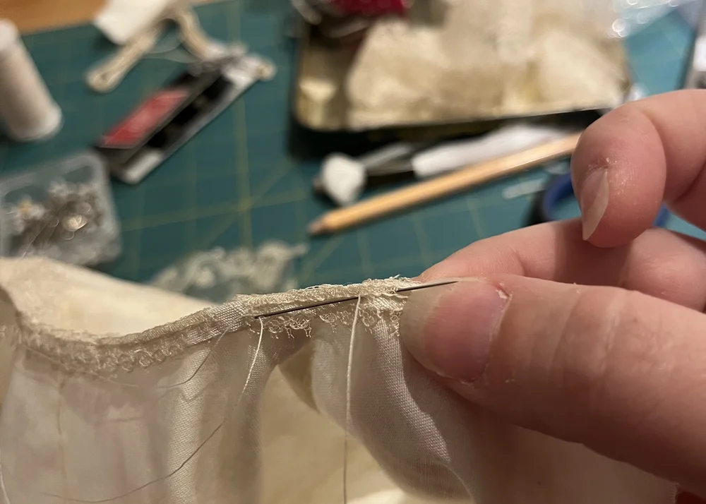 Tacking the lace inside the collar.
