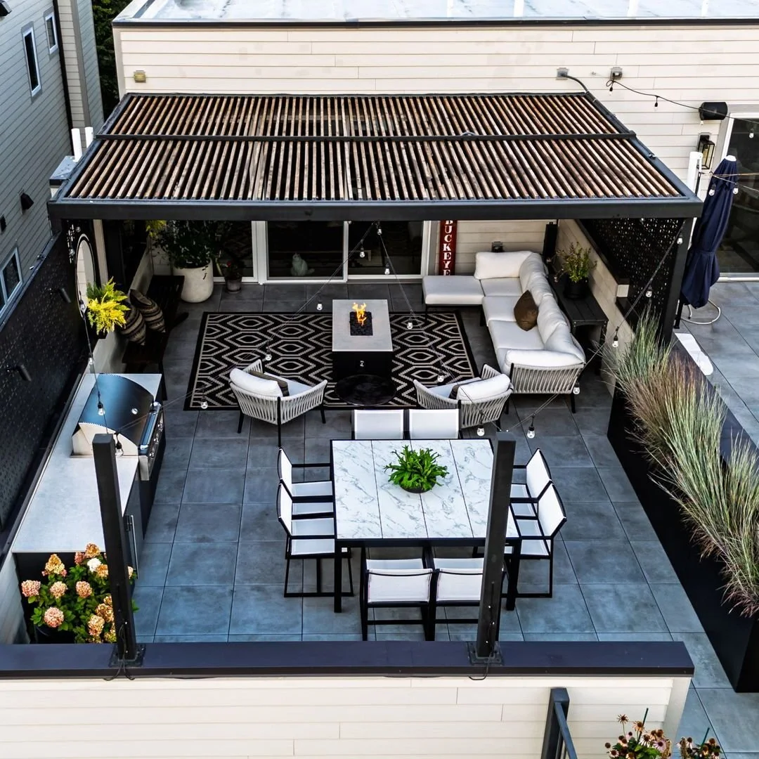 A cozy rooftop retreat with a custom Rooftopia pergola and privacy screens, outdoor grill, a lounge area with fireplace and a unique table for eight. Chicago sunsets are easy to enjoy as you dine al fresco or enjoy a movie under the stars.

Design/Bu