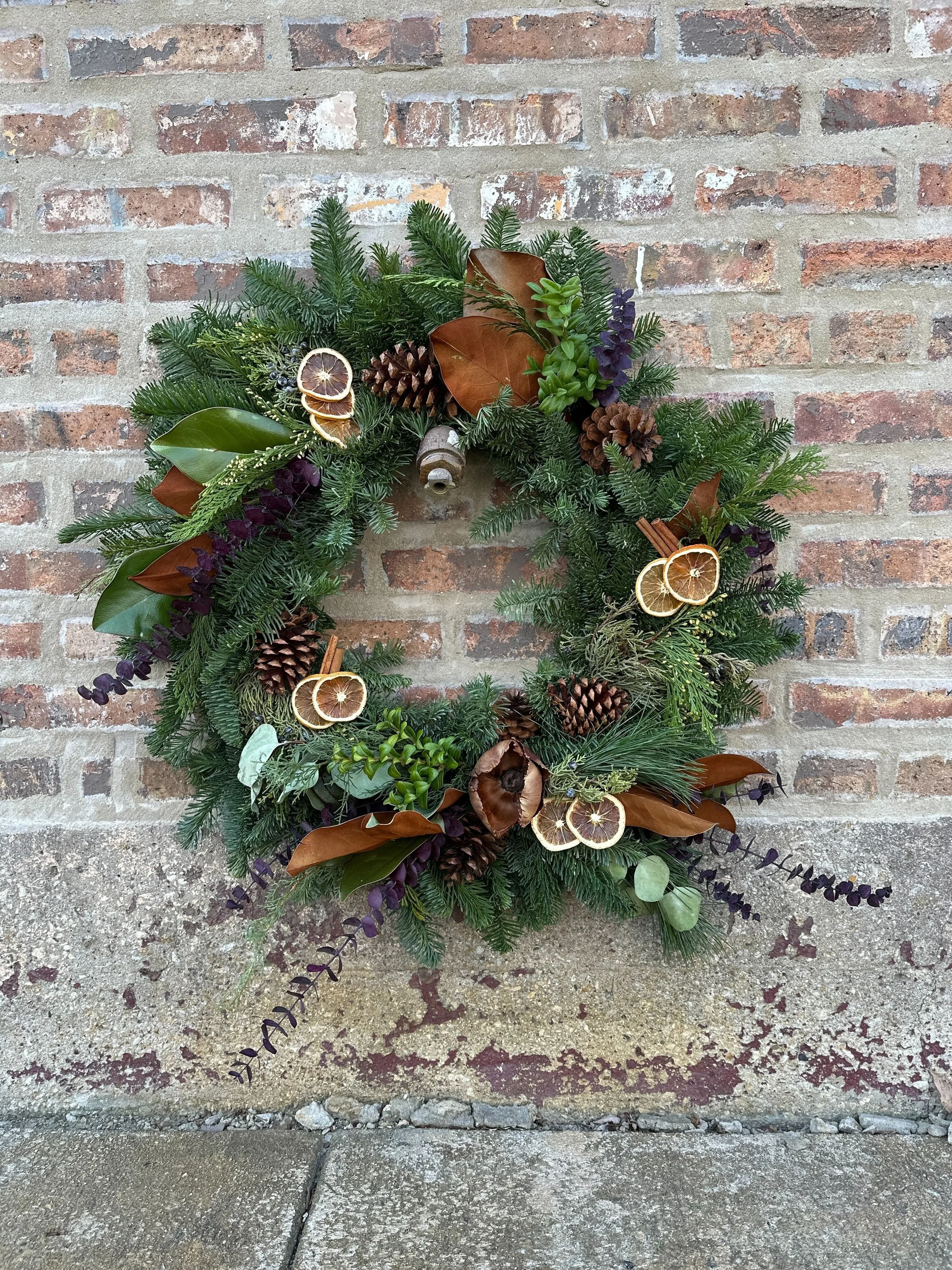 Rooftopia Holiday wreath with oranges and pincones.jpg