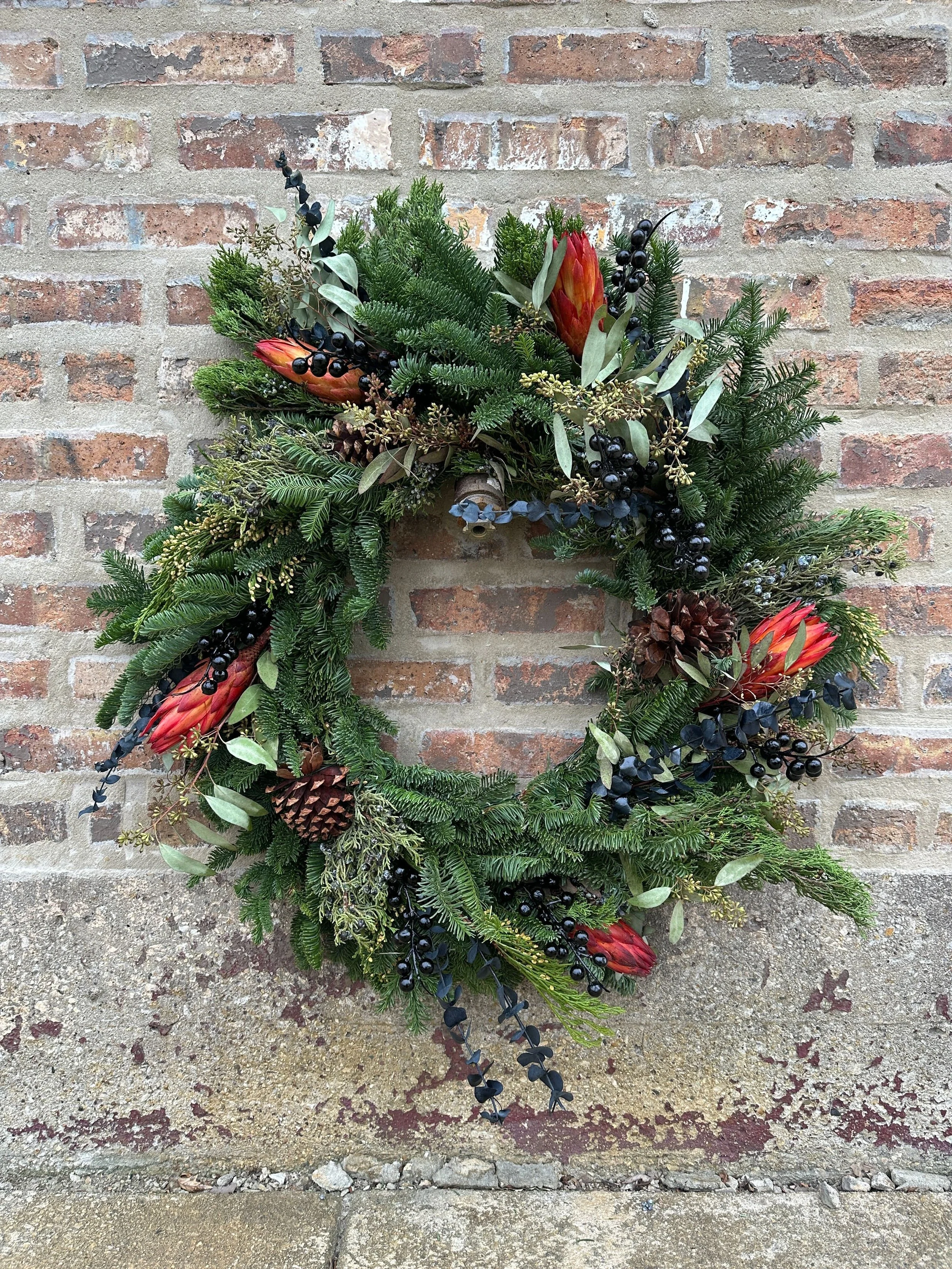 Rooftopia Holiday wreath with foliage and blooms.jpg