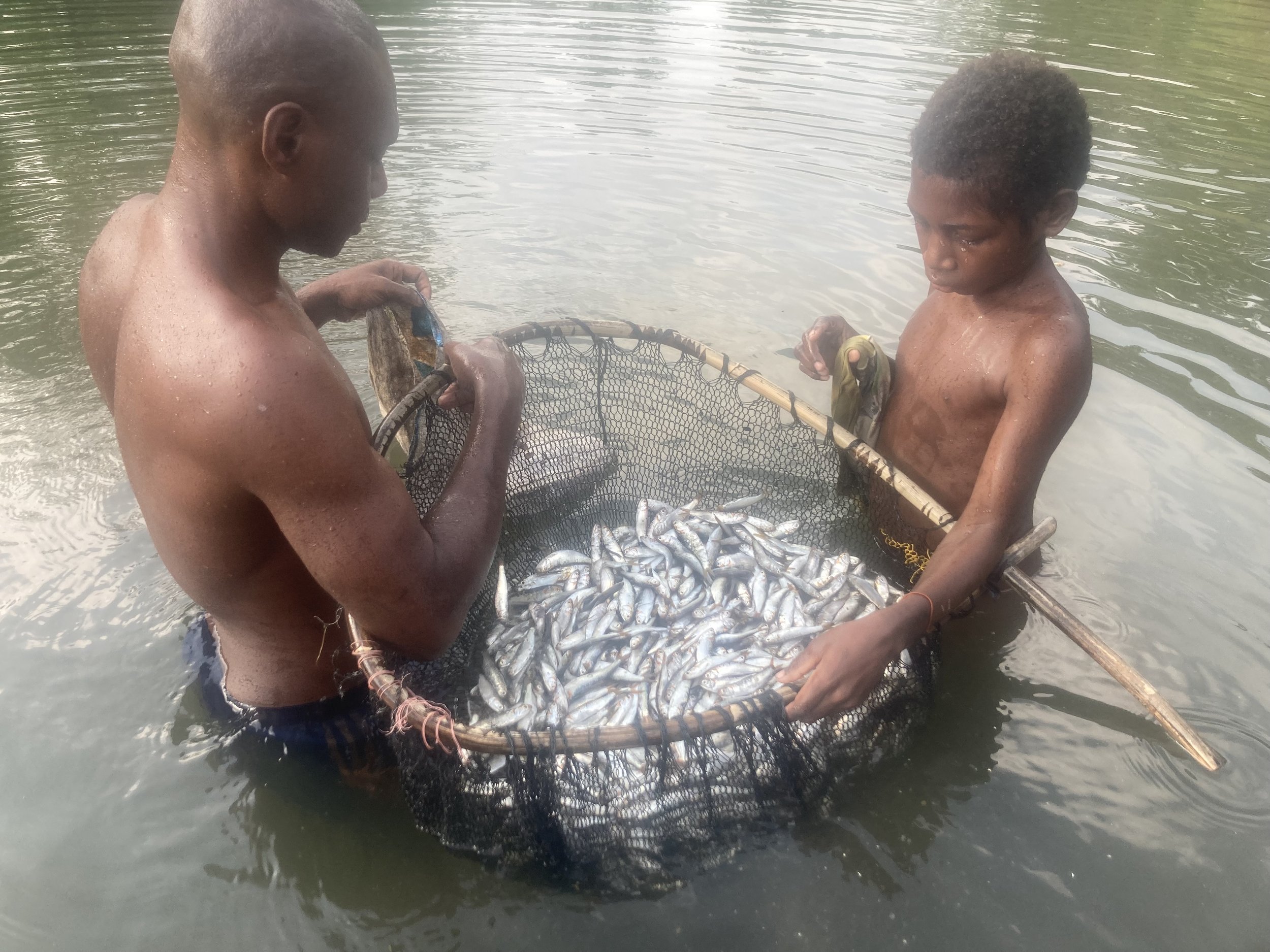 Elijah & his son Andy washing the fish we caught.