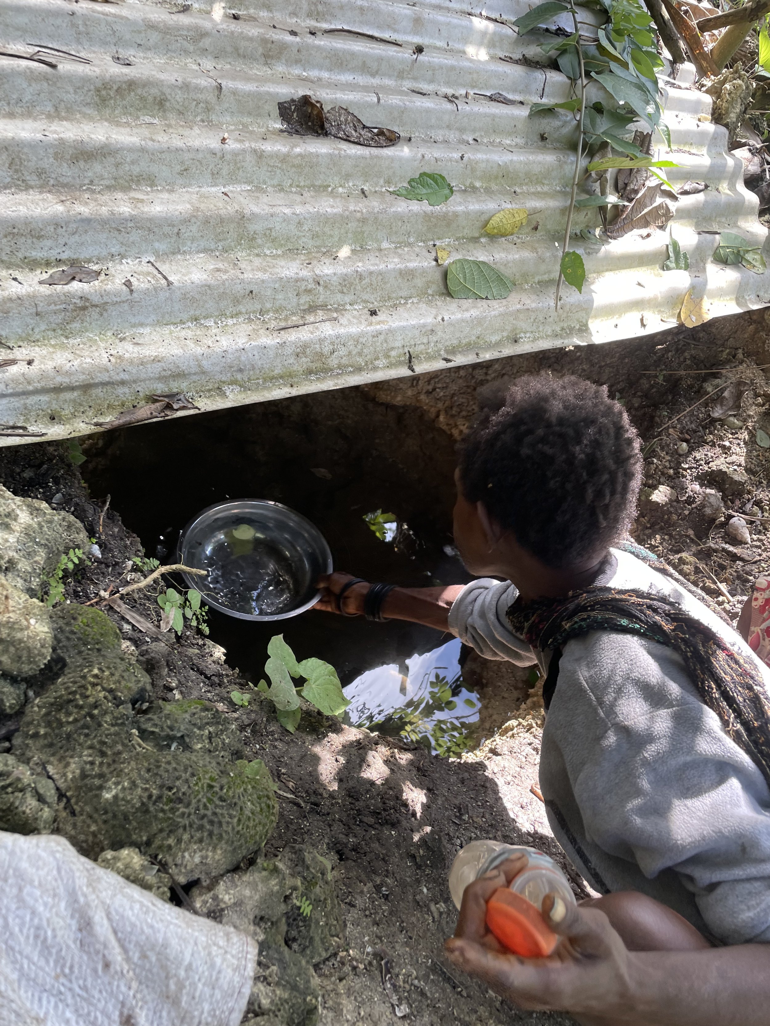 A woman getting drinking water for the day.