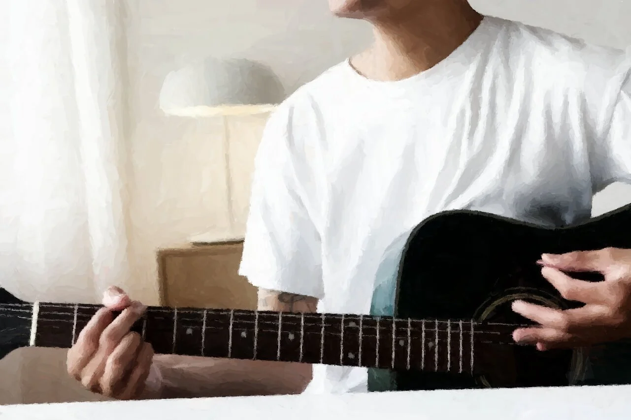 man playing a guitar, representing music therapy in Austin, TX for the treatment of anxiety, attachment issues, burnout, depression, grief or loss issues, self-esteem issues, spirituality issues, and trauma