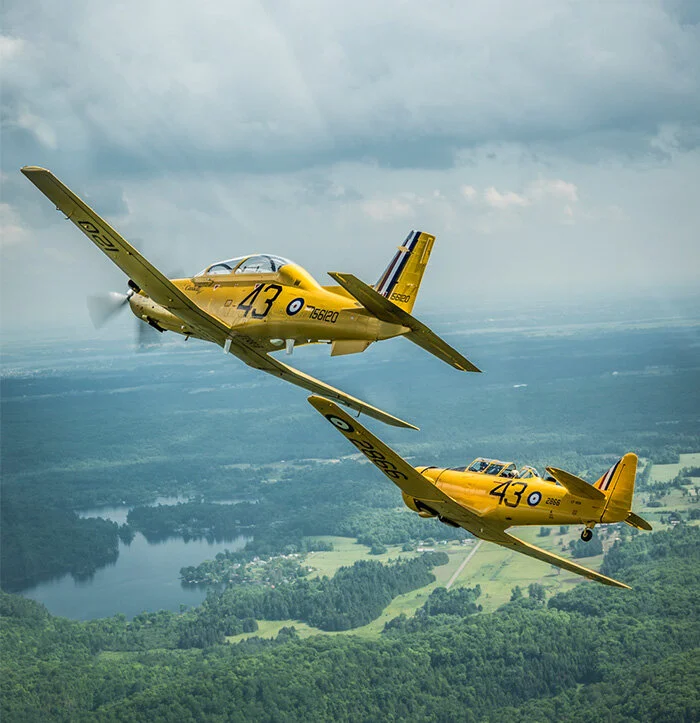 Peter Handley, one of the finest aviation photographers in Canada, captures the magnificent sight of not one, but two Harvards dedicated to a young man who left a lasting legacy for all of aviation. Here we see test pilot Rob Erdos in the Vintage W