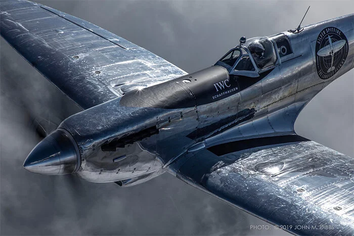 Another beautiful shot by John Dibbs. The Spitfire was stripped of all its paint in order to save the 300 lbs of paint it would normally carry—an idea that, combined with additional fuel tanks in the leading edge D-boxes, extended the range of the aircraft to 900 miles. Photo: John Dibbs