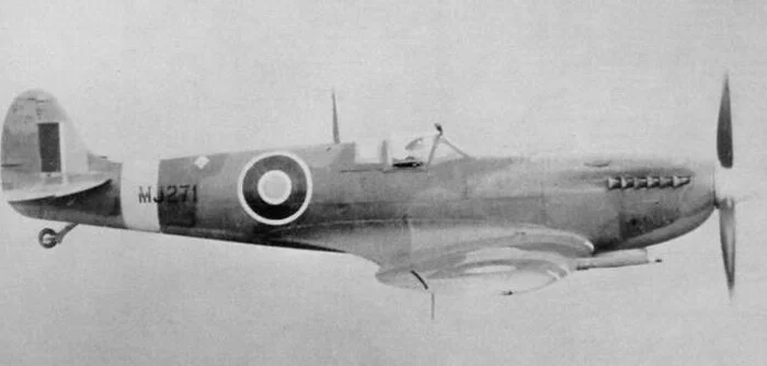 The only known photo of Supermarine Spitfire Mk IX MJ271. It is unknown when this photo was taken, but since there are no squadron markings and it looks freshly painted, it might be during a post-manufacture or post-maintenance test flight. This could have been taken either following its construction and delivery to 33 Maintenance Unit at RAF Lyneham where it was fitted with combat equipment and readied for frontline service, or perhaps after it emerged from the repair hangars following its wheels-up landing at RAF Ford while flying with 132 Squadron. Sadly, the 132 Squadron ORBs were not as detailed as those of 401. The squadron adjutant responsible for keeping the ORBs and records of events did not record any aircraft serials and in the events summary made no mention of the wheels-up landing, making it difficult to determine who flew MJ271 the day it was so seriously damaged. It is curious to see the pilot wearing his officer's cap rather than a helmet. This leads me to believe that this photo was taken during the delivery flight from the Supermarine factory at Castle Bromwich to 33 Maintenance Unit for installation of radios and guns. There would be no need for a helmet with radio headphones as there was no radio. The hat badge seems larger and brighter than a typical RAF pilot would have, and matches more that worn by most Air Transport Auxiliary pilots.