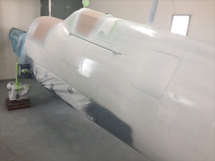   Master painter Korrey Foisy completes the first coat of “Polar” white, as per&nbsp;specifications for the Arctic Reconnaissance and Patrol (APR) standard set out by the RCAF in 1943. Photo: Korrey Foisy&nbsp;  