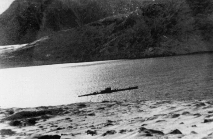 U-537 anchored in secluded Martin Bay, Labrador in pale winter sunlight on the morning of 22 October 1943. This shot was taken from the bluff where the weather station was being set up. The crew and the three Siemens technicians, led by Ku…