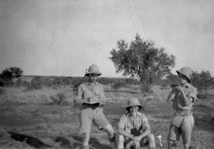 Hugh Bone (right) with two course mates on the Rhodesian grassland check their bearings and course during a “bundu bash”, an orienteering exercise that exposed them to the real Rhodesia during their time at Initial Training Wing Hillside. Photo…