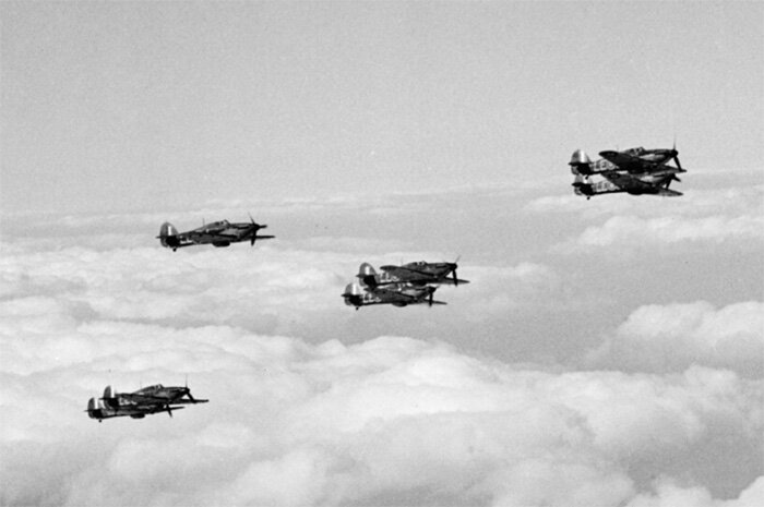 Hawker Hurricanes of 242 Squadron rise above the clouds during the Battle of Britain. Photo: Imperial War Museum