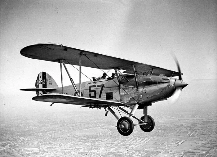 Trevor Southgate earned his coveted RAF pilot’s brevet on the Hawker Hart/Audax, two variants of the same aircraft of the last group of high performance biplanes in the service of the Royal Air Force. The Hawker Hart was a British two-seater light bomber aircraft of the RAF. It was designed during the 1920s by Sydney Camm, the future designer of the Hurricane. The Hart was a prominent British aircraft in the interwar period, but was obsolete and already sidelined for newer monoplane aircraft designs by the start of the war. RAF Photo via HawkerHind.com