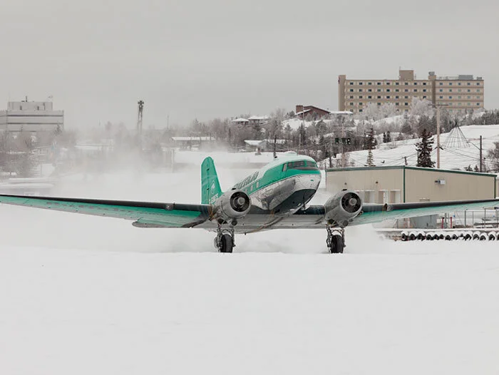 Far, far away and seventy years after rescuing Belgians from Nazi concentration and forced labour camps, RAF Dakota KG330 thunders down an ice runway in Yellowknife, Northwest Territories on Great Slave Lake. Photo: Jason Pine Photography