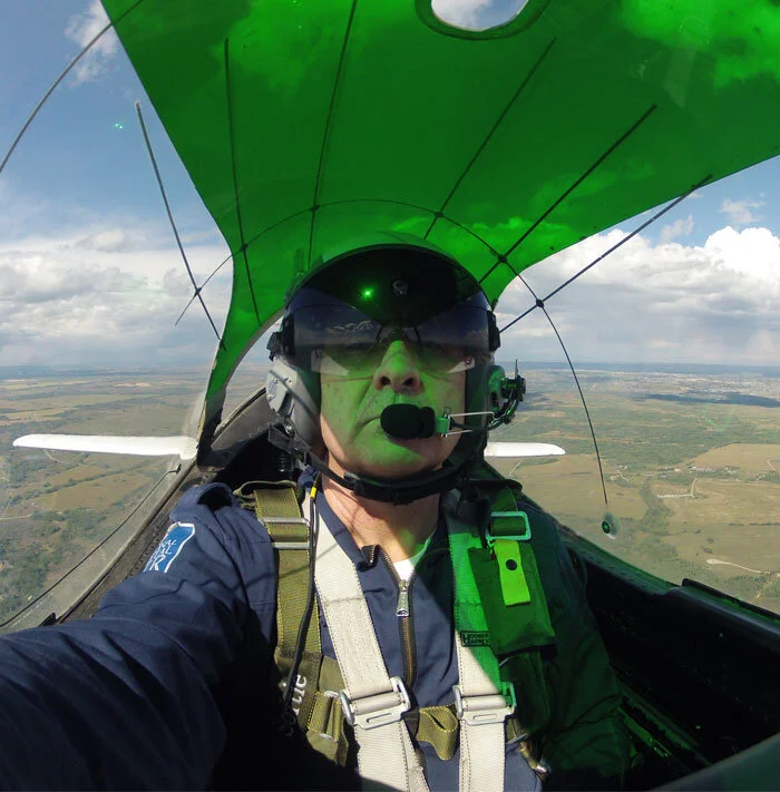 Somewhere over the Alberta prairie, I take a self-portrait as we climb to 11,500 feet en route to Regina, Saskatchewan. The particular T-28B Trojan owned by Evans has a green sun-shade at the top of the canopy. This makes it very comfortable inside the cockpit on sunny days and casts a very dramatic green light throughout the cockpit. Life suddenly was a whole lot better. Photo: Dave O'Malley