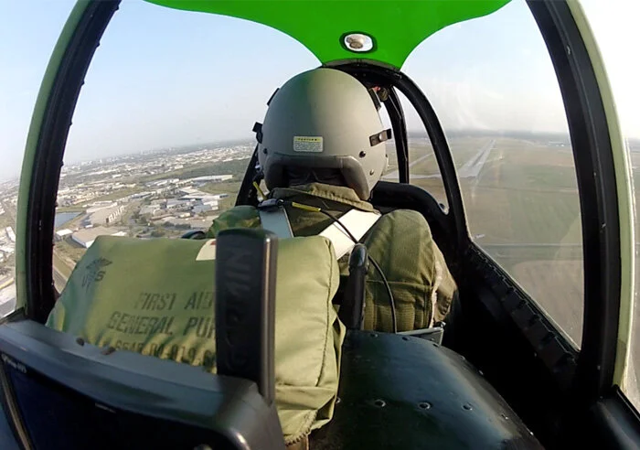At the end of a long day, Professor Evans takes control and lines up the runway at Winnipeg, foregoing the overhead break at the busy airport. The sweeping visibility offered by the T-28 is clearly evident on the image. Photo Dave O'Malley