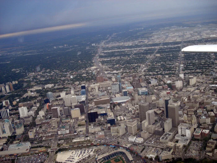 In the grey light of morning, the plains city of Winnipeg passes beneath us as we turn to the east. Ahead, at 7,500 feet lay a heavy cloud layer mixed with forest fire smoke which stretched to the east as far as Kenora. To get to the open weather and better visibility we churned eastward though some frisky weather. While strapped to your passenger seat in the long humanity-filled tube of an airliner, this experience might be uncomfortable, but belted tightly to the seat of the T-28, this was simply joyful fun banging our way to Thunder Bay. Photo: Dave O'Malley