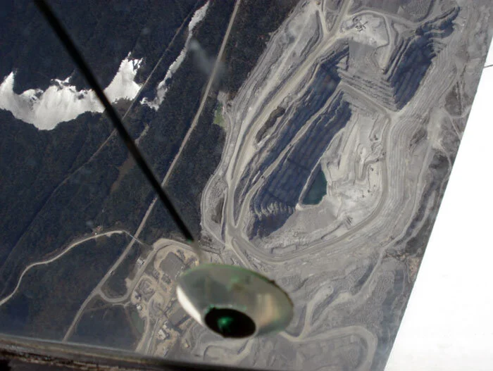 The massive gaping maw of Barrick's Williams Open Pit Gold Mine at Hemlo, Ontario is an old stomping ground for Professor Evans. The mine, about 40 kilometers east of Marathon, Ontario, output an astonishing 227,000 ounces (more than seven tons) of gold in 2011. As we made a couple of turns overhead the three separate mines at the remote Northern Ontario location, he filled me in on the history of the operation and his experiences down on the ground during the wild and wooly early days of exploration. Gold was discovered in the Hemlo area in 1869 but it wasn't until the 1940s that trappers, prospectors, geologists and investors staked claims covering some newly discovered occurrences that, later on, turned out to be the claims from where gold would be extracted in modern times by the Hemlo mines. The object in the bottom of the photo is not a UFO, but rather part of the canopy defrost system. Photo: Dave O'Malley