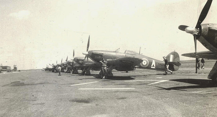 Another photo taken at Mossbank shows most of the squadron's Hurricanes (5403 in the foreground), many with newly applied bulldog nose art. The logo was adopted prior to their departure for Patricia Bay. Photo via Mark Peapell, Atlantic Canada Aviation Museum