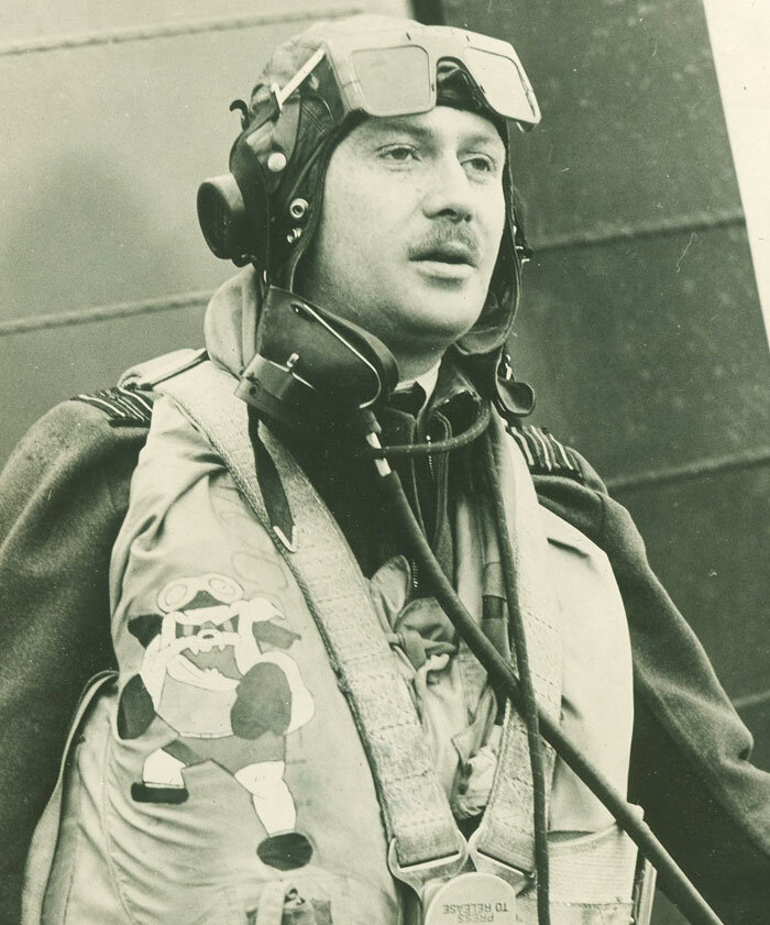 The 135 Squadron Commanding Officer Squadron Leader W. C. Connell shows off his Mae West with the unit's new Fighting Bull Dog emblem painted on it. A rare tradition, the emblem was worn on the Mae Wests of all 135 Squadron pilots. Connell was the C…