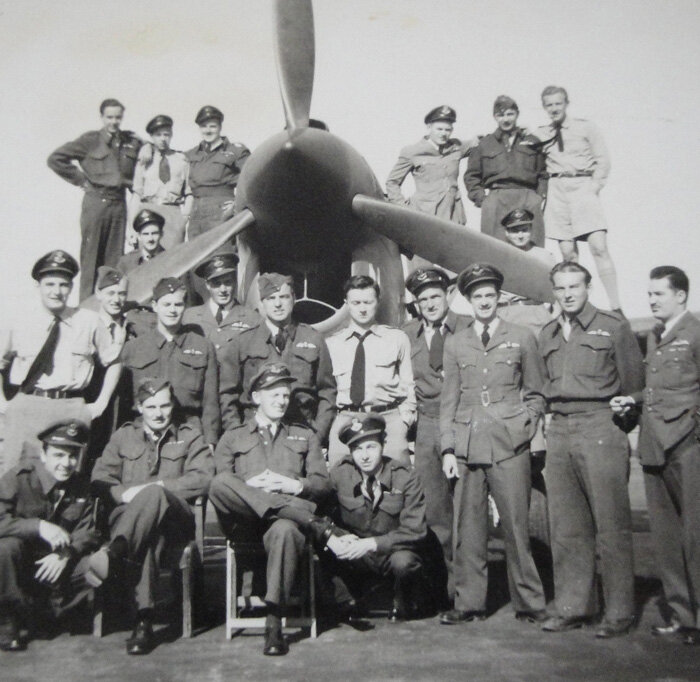 The pilots of 135 Squadron stand before a Kittyhawk sometime between May 1944 and the end of the war.