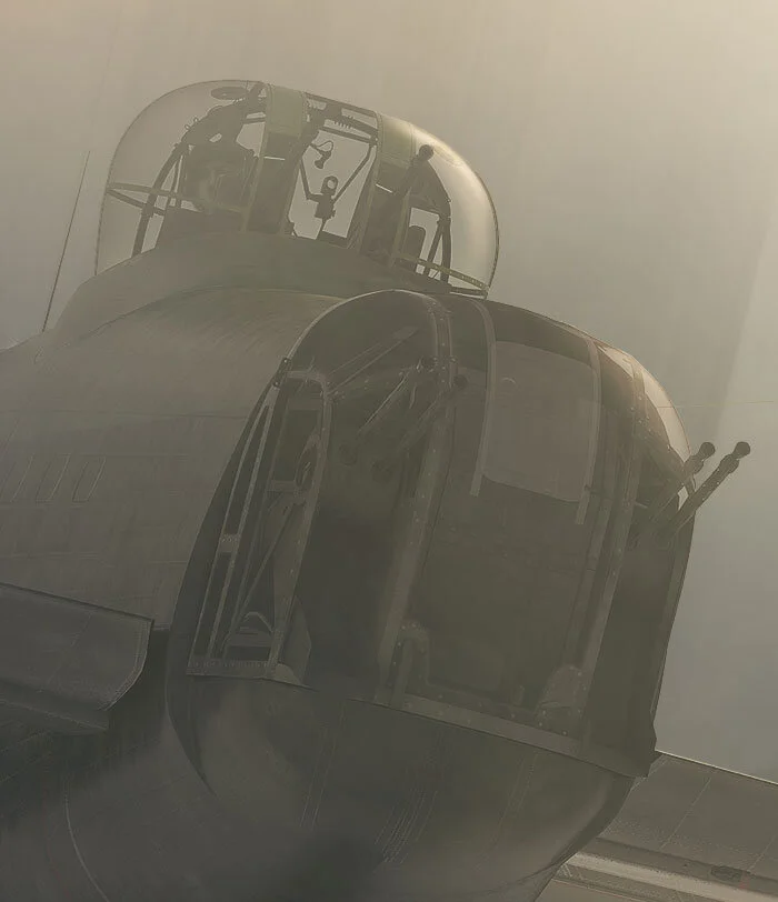 For now, the mid-upper gunner can relax a bit as he and his fellow crew slip into the protection of the clouds. Still, he appears worried. Detail from Through Clouds by Piotr Forkasiewicz