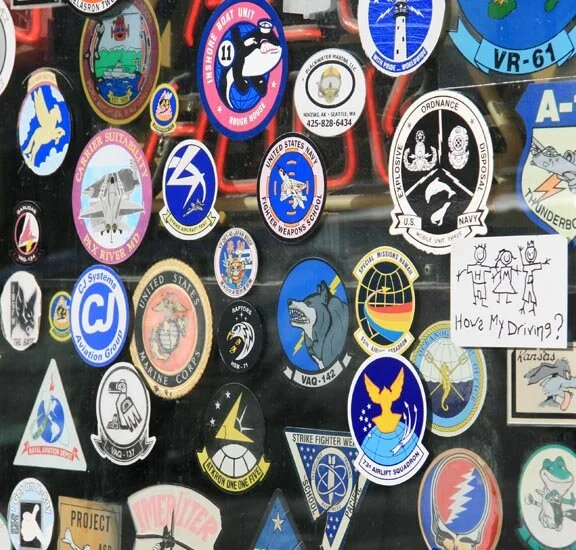 A door of a Coupeville, Washington restaurant frequented by military aircrew is festooned with zappers—a great way to mark your territory, but again, a low degree of difficulty. The photographer Robyn notes that there is everything from Grateful Dead (bottom right) to US military squadrons (mostly Navy and Marines.) The Naval Air Station Whidbey Island just down the road would account for the plethora of zappers. Photo by Robyn Hanson at Flickr.com