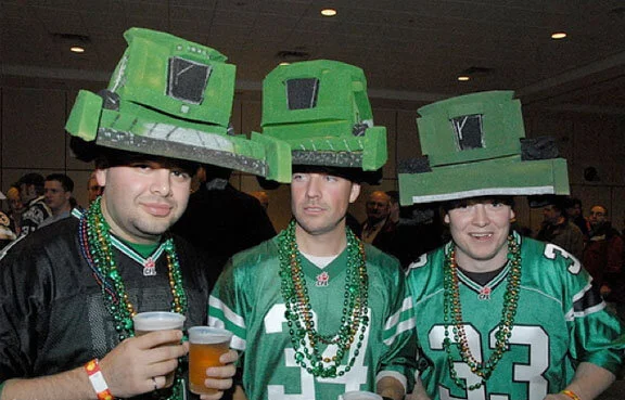 The Saskatchewan Roughrider fans are, if anything, the most creative costumers in the league. Many sport hollowed out watermelons on their heads as homage to the team’s green helmets. This trio of Rider fans wears homemade John Deere wheat combines—the better, I suppose, to mow down the competition. Photo by gore84 at flickr.com
